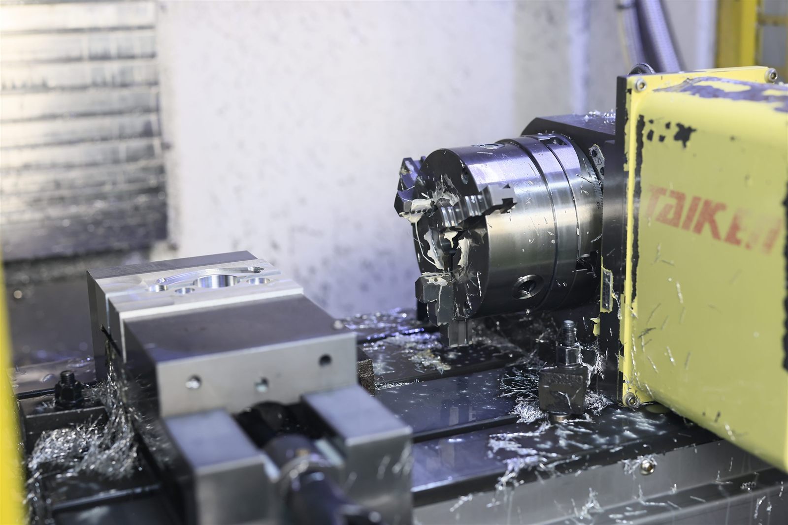 Combined CNC mill-turn machining a part