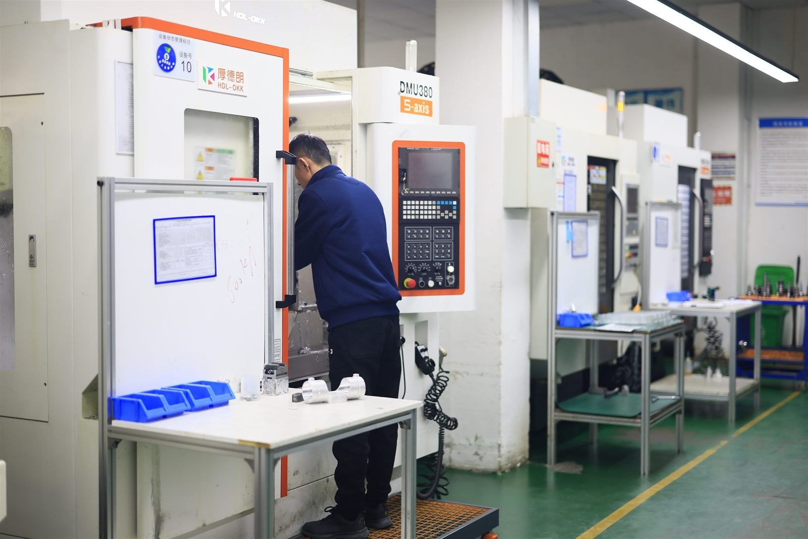 5-axis CNC machine on a clean production floor