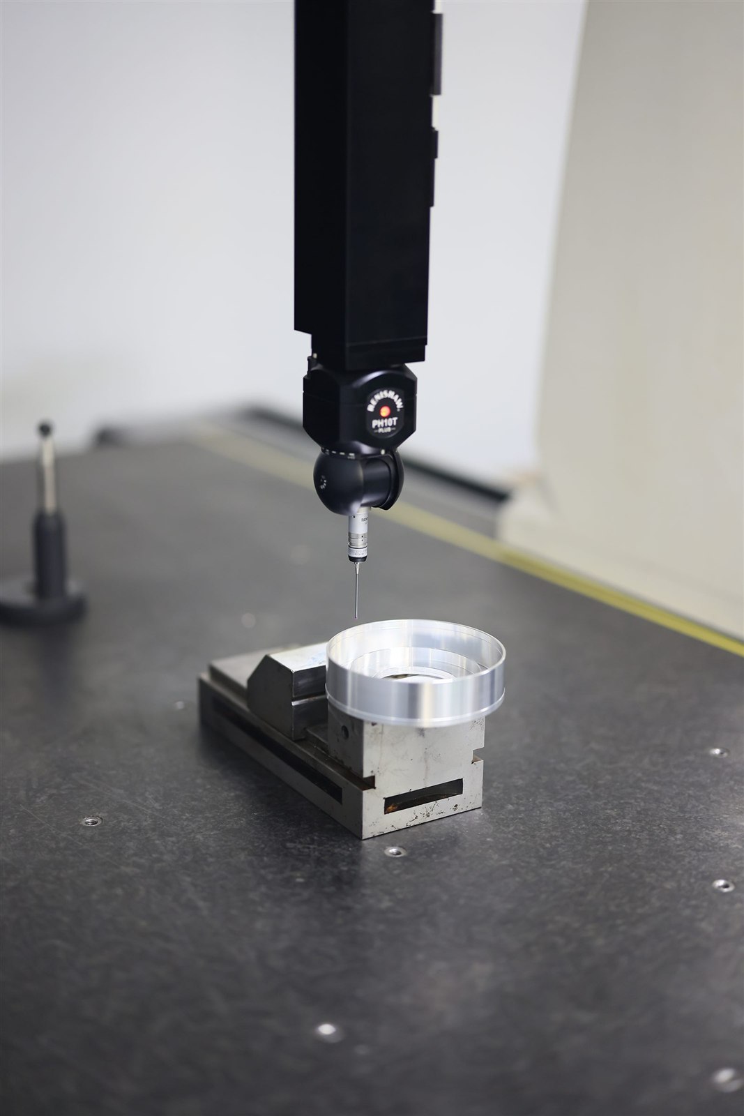 CMM probe inspecting a precision machined part