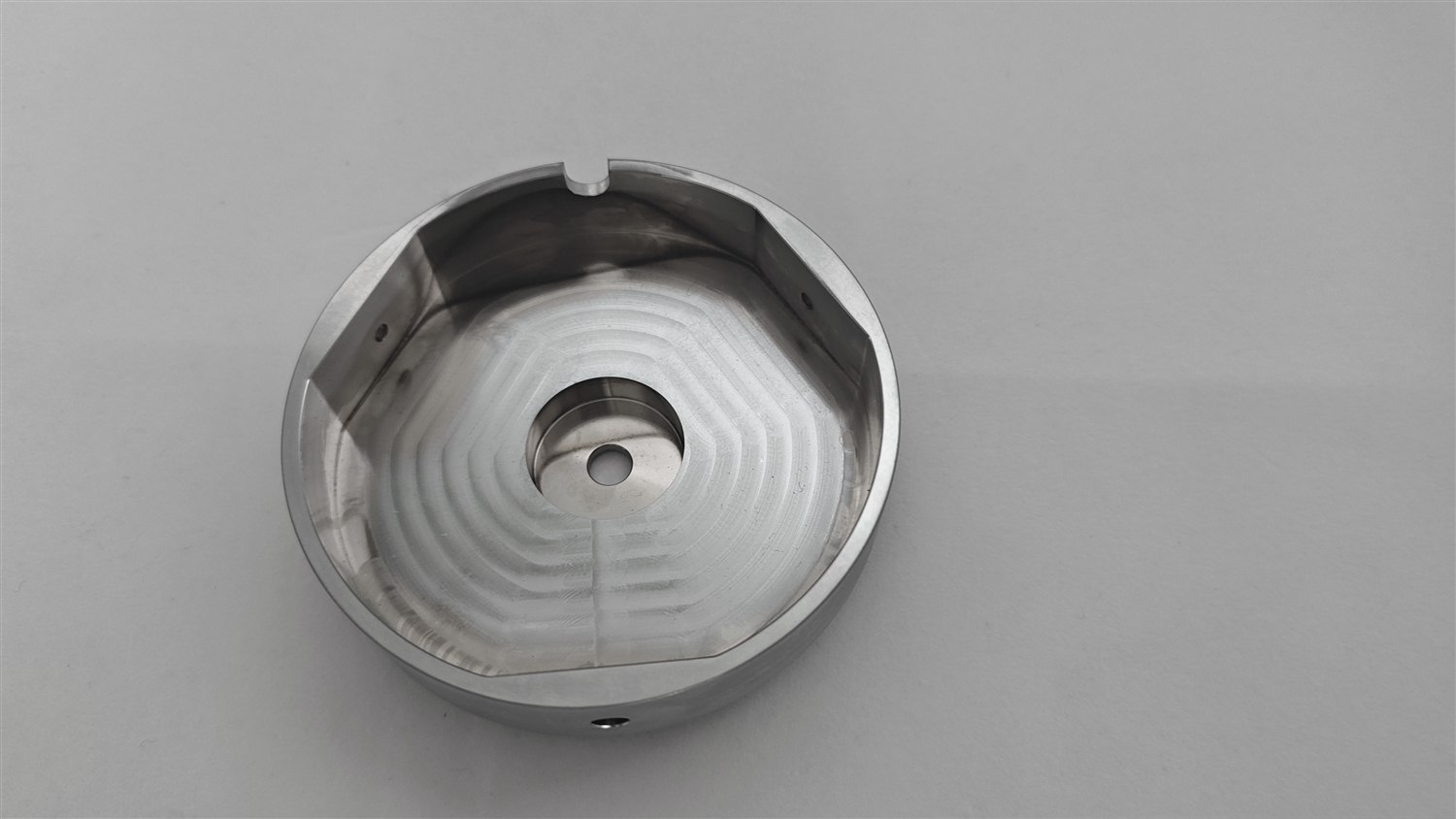 Single finished aluminium part showing an internal pocket and cleanly machined floor