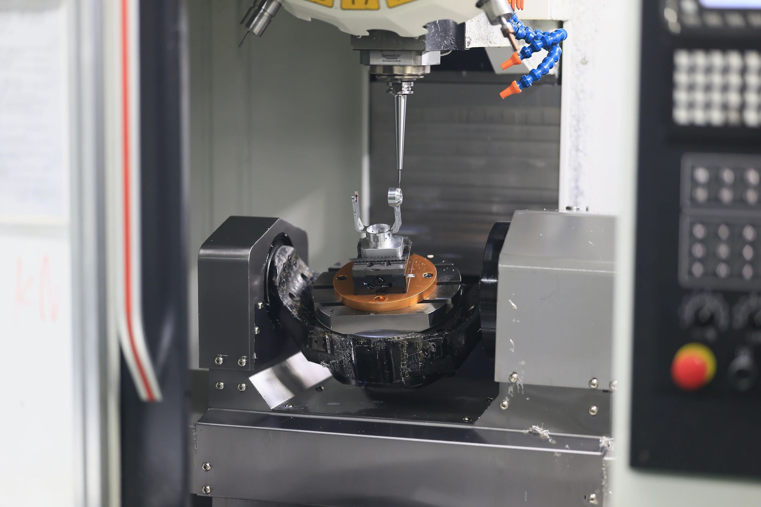 5-axis machined aluminium bracket clamped on the rotary table