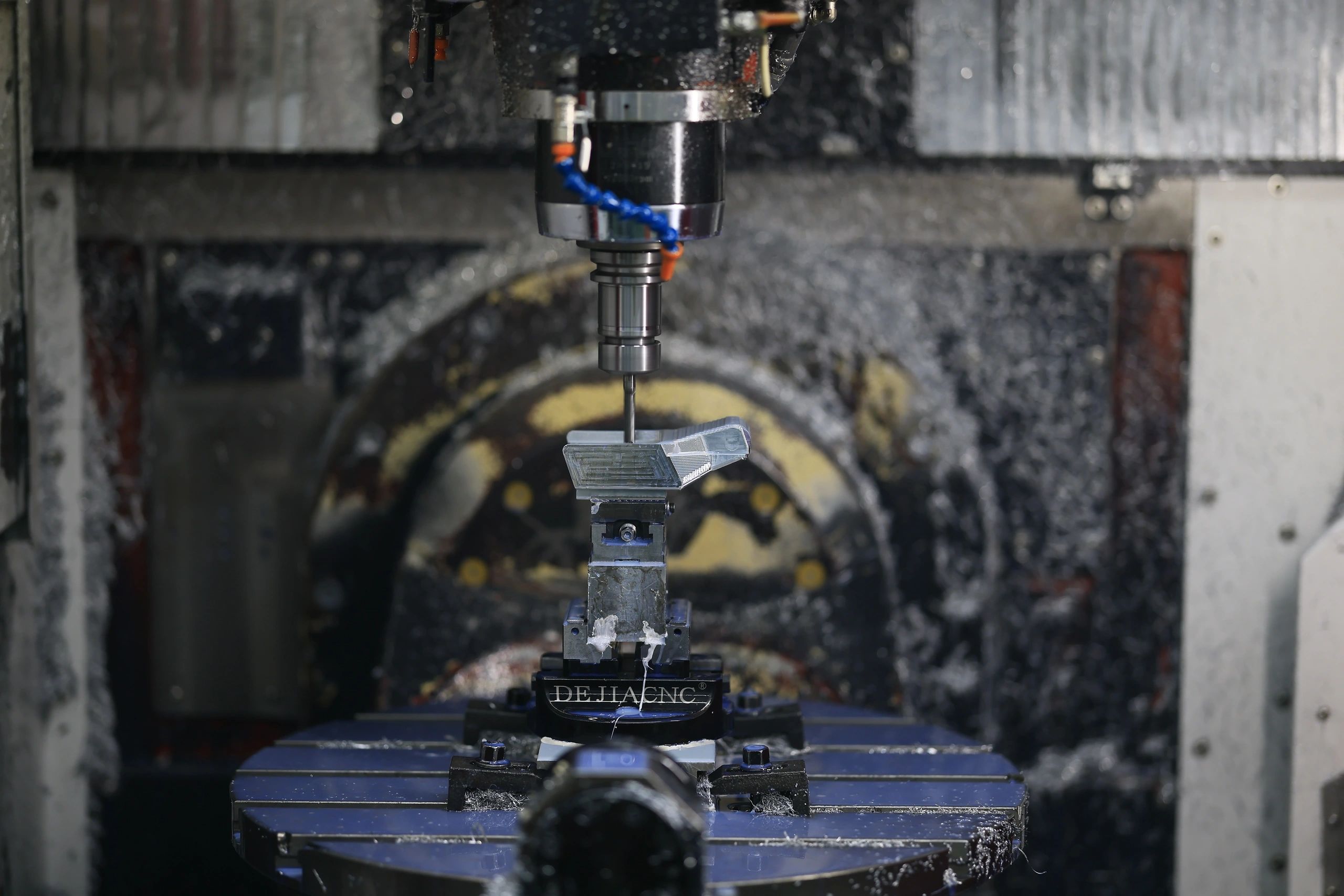 5-axis machined aluminium component clamped in a precision vise