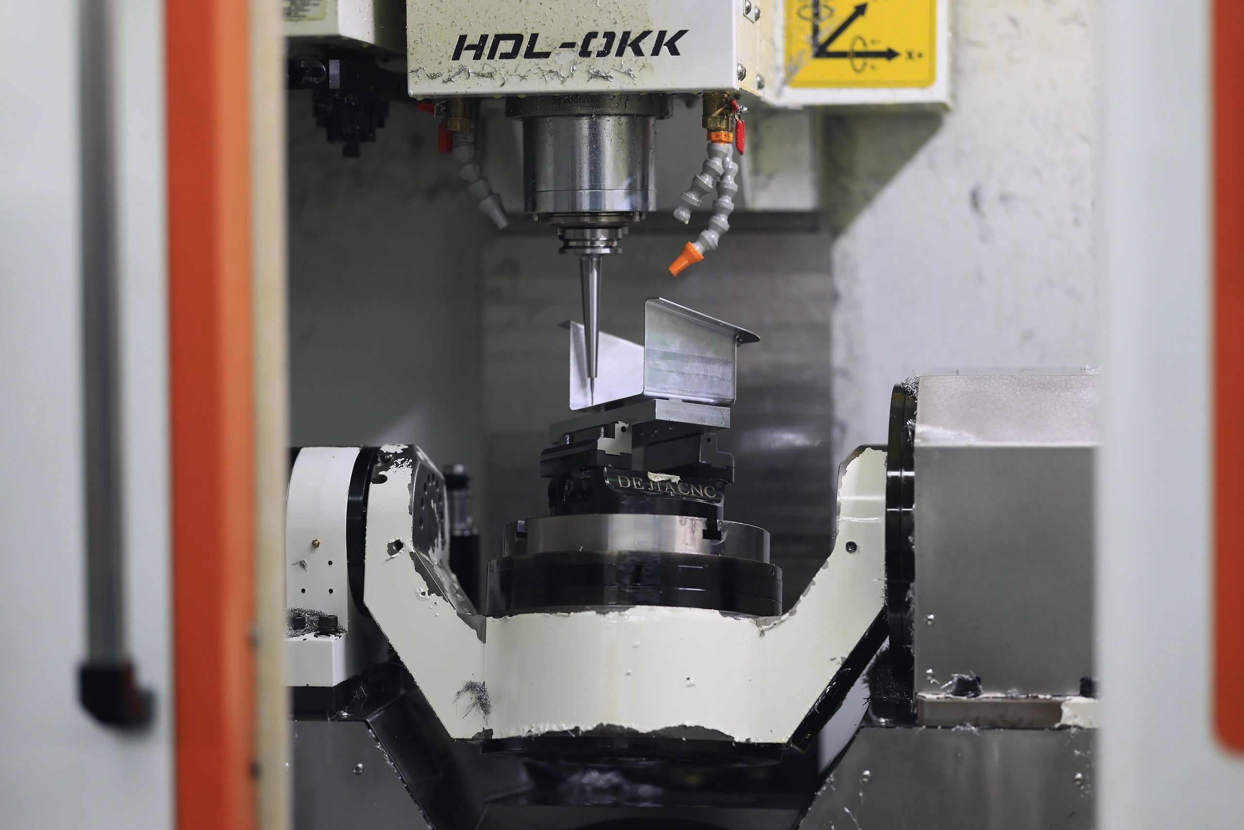 5-axis machined aluminium angle bracket in a 3-jaw chuck