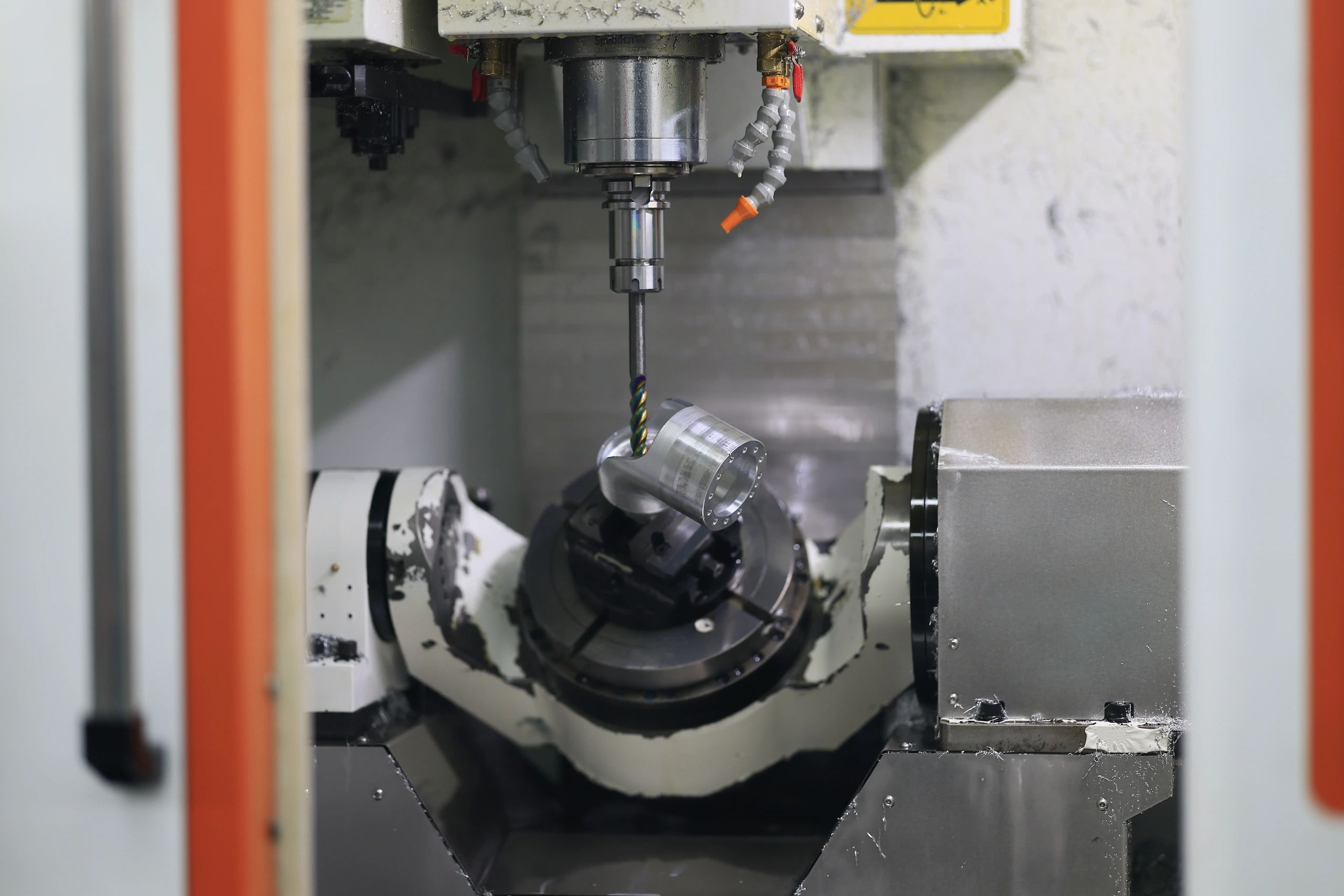 5-axis machined aluminium flanged housing held in the chuck