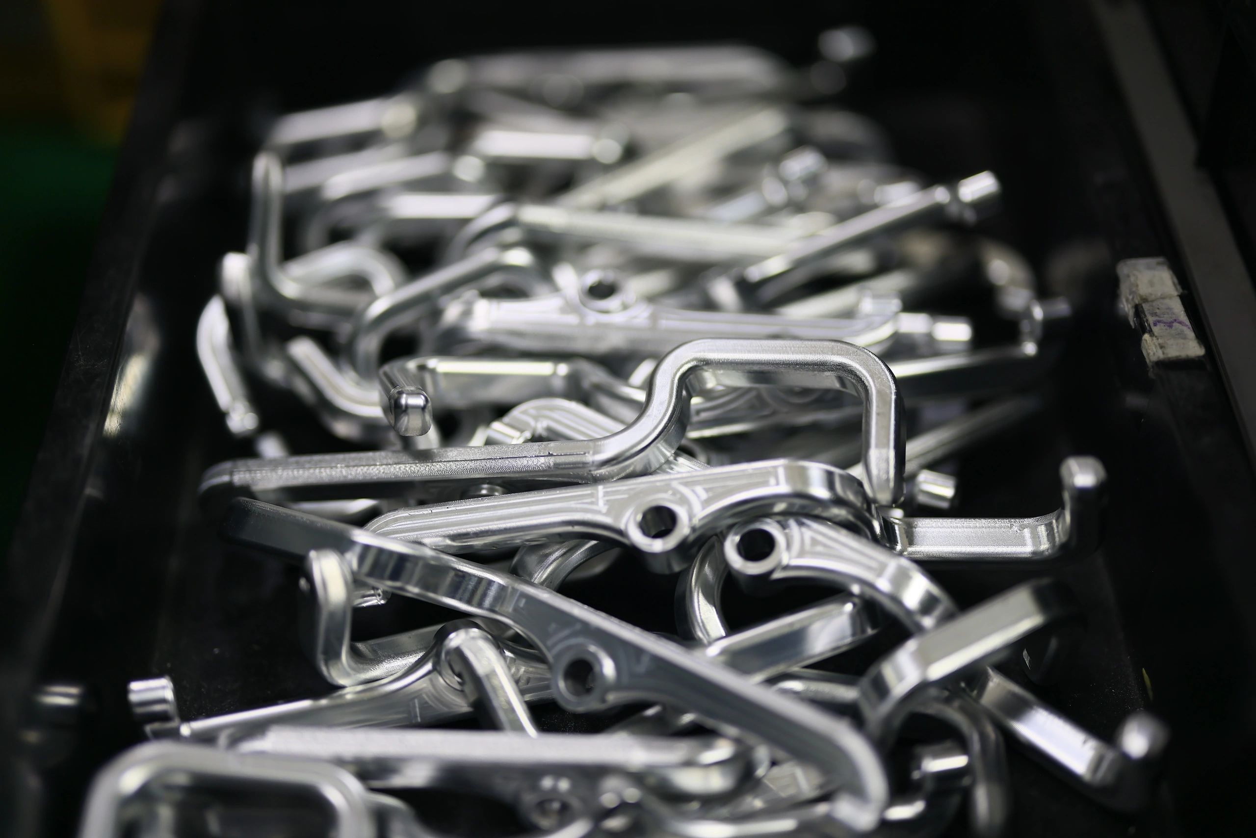 Bin of high-strength CNC-machined components for industrial machinery