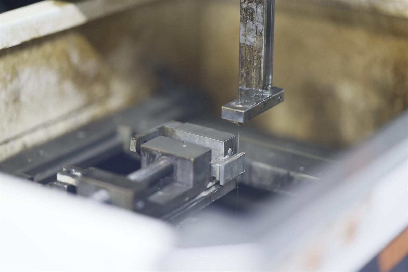 Detail of a wire EDM work zone cutting a fixtured workpiece