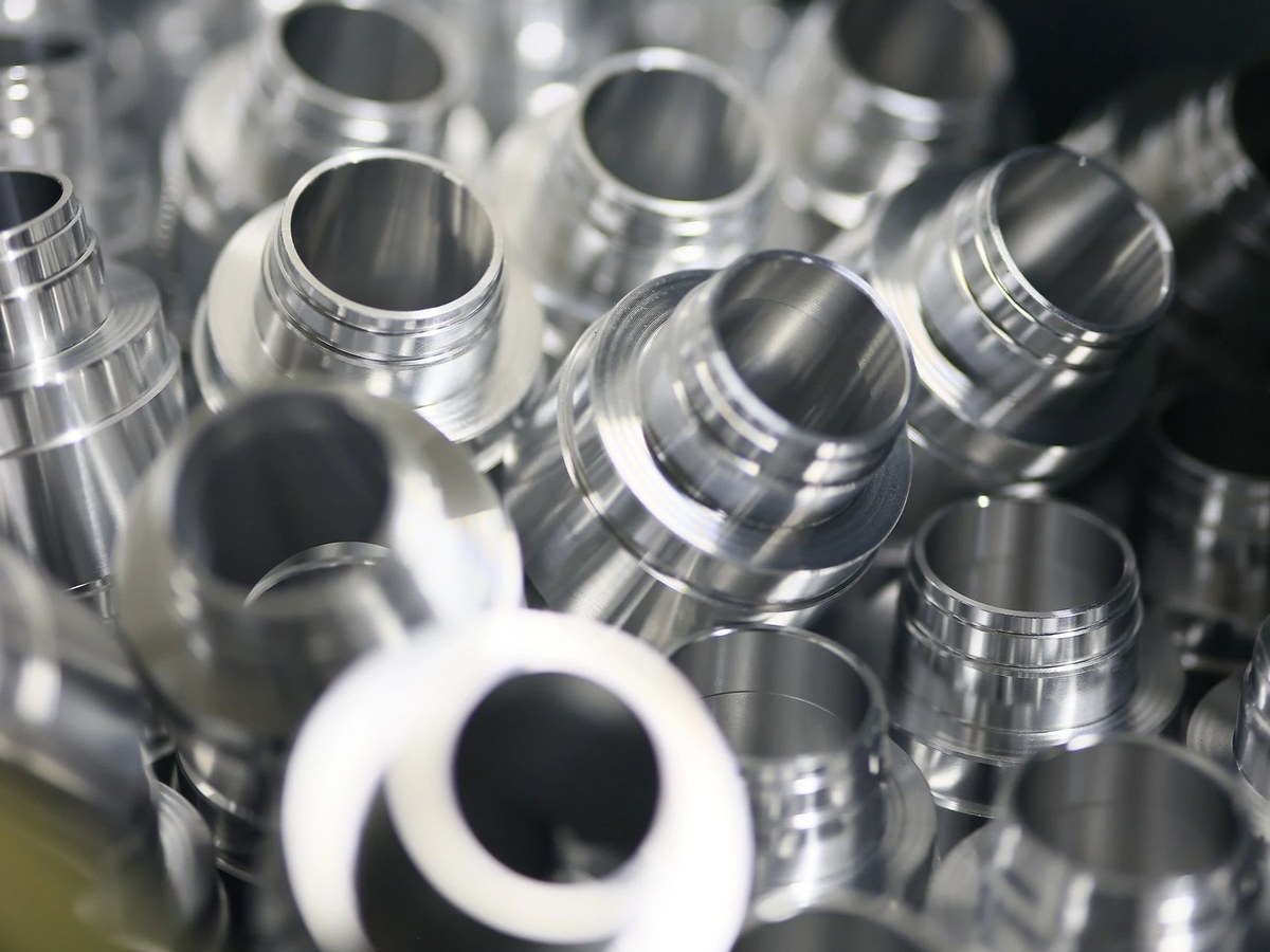 Batch of CNC turned aluminium sleeve components for EV systems