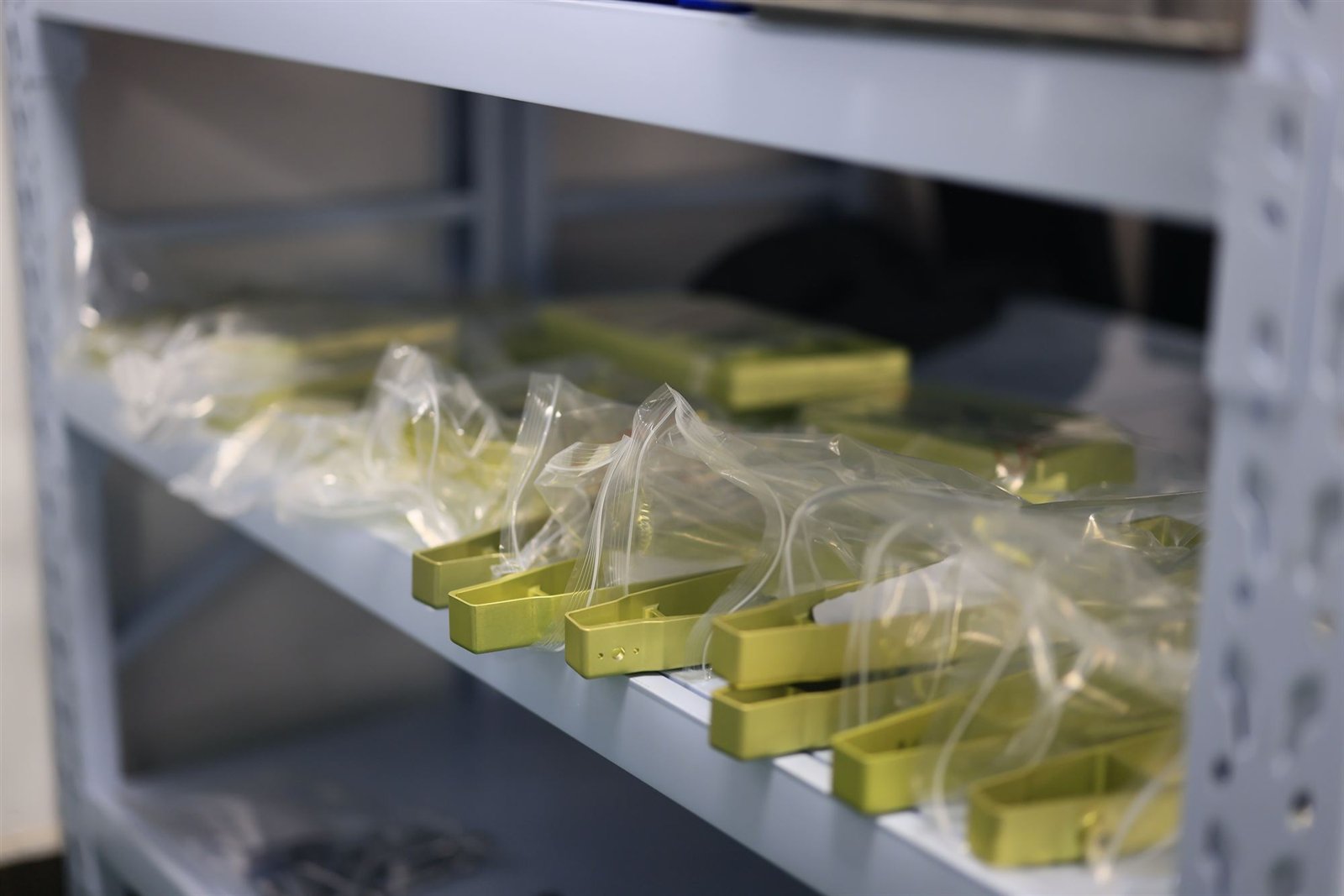 Finished anodised aluminium components, individually bagged and staged for inspection and shipping