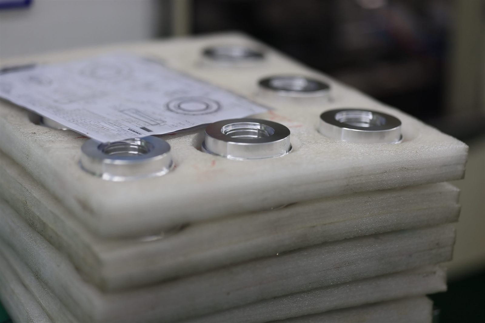 Foam-packed CNC parts with inspection paperwork, ready for shipment