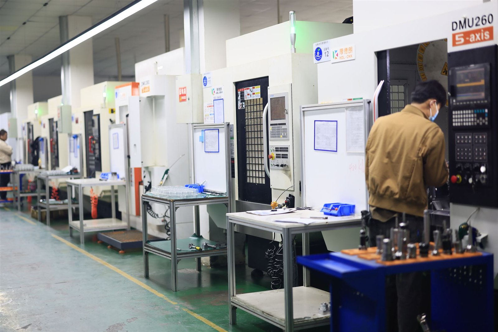 Row of 5-axis CNC machines on the Fenva Precision production floor