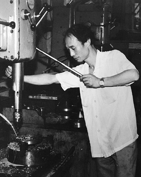 Mr. Shen, founder of Fenva Precision, at a machine in the early years